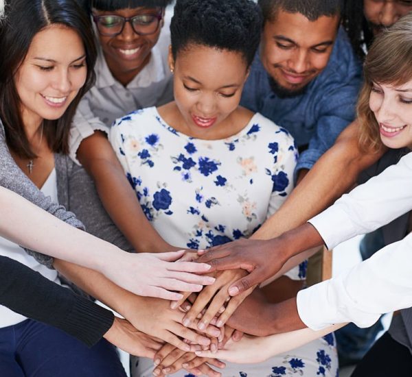Shot of a group of people putting their hands together
